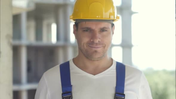 A Handsome Construction Worker Giving a Thumbs-up Sign alt
