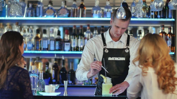 Bartender making and decorating cocktail