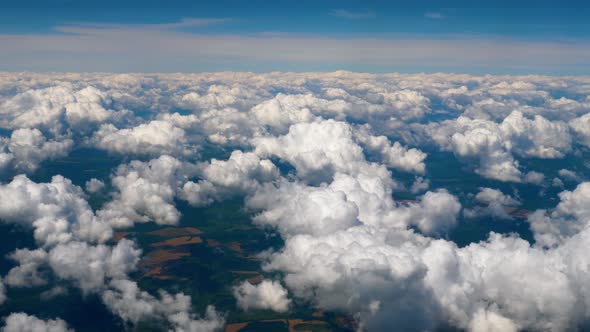 Beautiful Amazing View To the Sky From the Aircraft. Aerial View of Clouds Over Landscape From