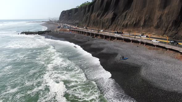 4k daytime aerial fast footage of the Pacific Ocean hitting its powerful waves on the Miraflores coa alt