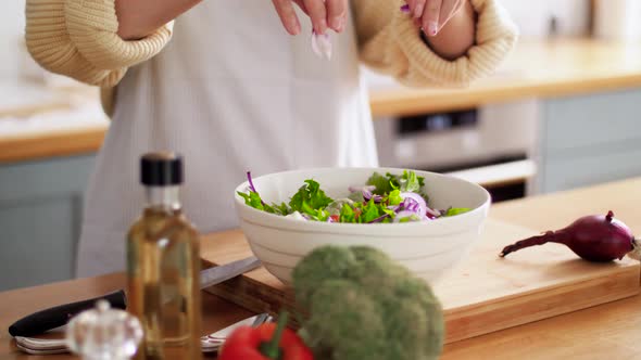 Hands of Woman Cooking Vegetable Salad on Kitchen