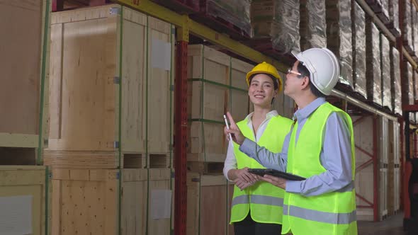 Warehouse worker checking quality control or parcel in distribution center