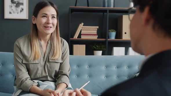 Cheerful Young Lady Talking to Therapist and Smiling Feeling Relief and Happiness alt