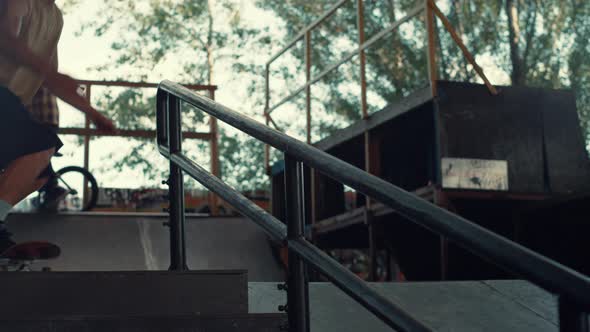 Active Teen Skater Jumping on Rail with Skate Board at Urban Skate Park alt