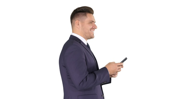 Mature businessman using mobile phone texting message on alt