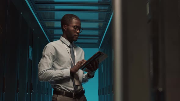 Professional IT Specialist Maintaining Operational Server Racks alt