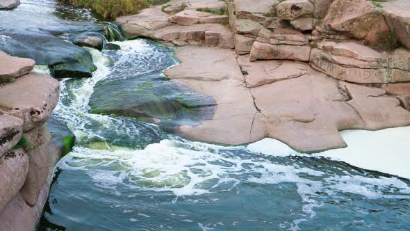 A Small Shining Stream Flows Among Smooth Wet and Dark Stones alt