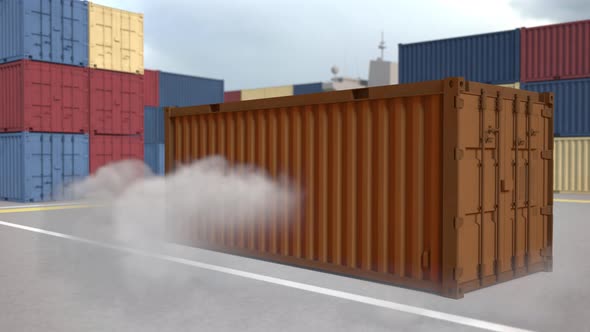 The orange container falls with clouds of dust