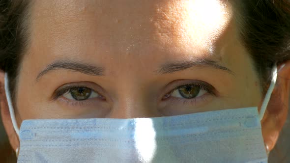 Wearing a medical mask during the Covid epidemic. Close-up of a young woman's face