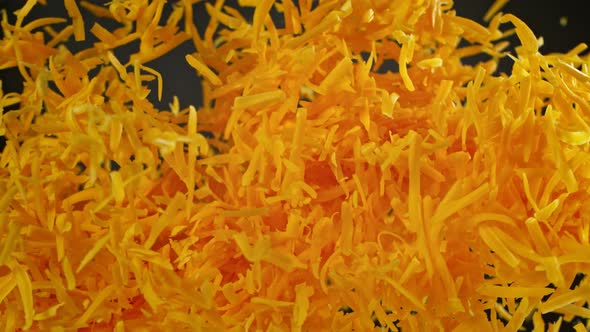 Super Slow Motion Detail Shot of Flying Grated Cheddar Cheese at 1000 Fps. alt
