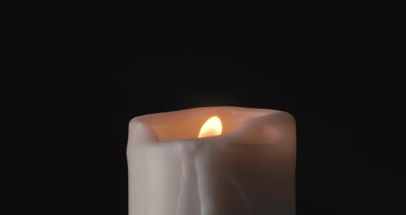 White Candle on Black Background alt