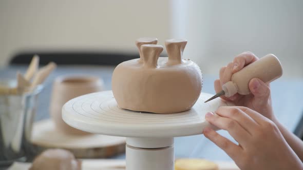 Child in the Process of Decorating the Clay Vase. Children Pottery Studio.