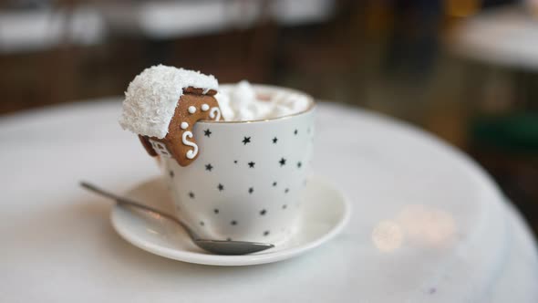 The Mug with the Christmas Decorations and Cookie on Edge alt