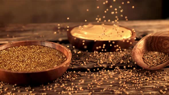 Super Slow Motion on a Wooden Table Falling Grains of Fresh Mustard alt