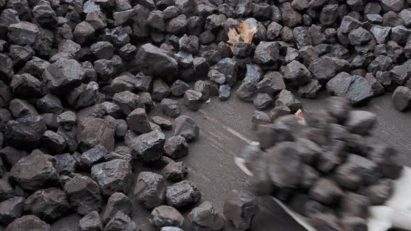 Stacking a pile of coal with a shovel. Preparation for the heating season.