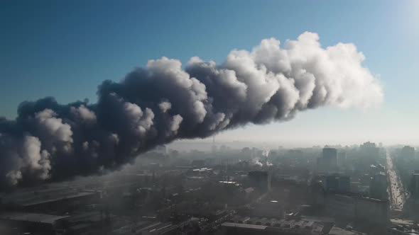 Aerial drone view of industrial smoke coming from pipe factory tube. City pollution idea alt