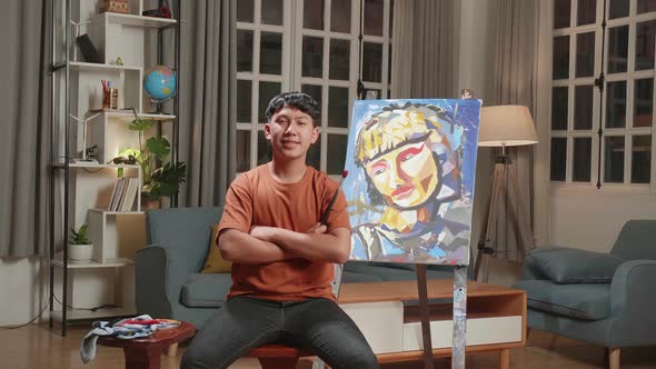 Asian Artist Boy Crossing His Arms And Smiling After Finish Painting alt
