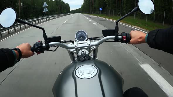 First Person View of Driving on a Motorbike at the Highway Through the Forest alt