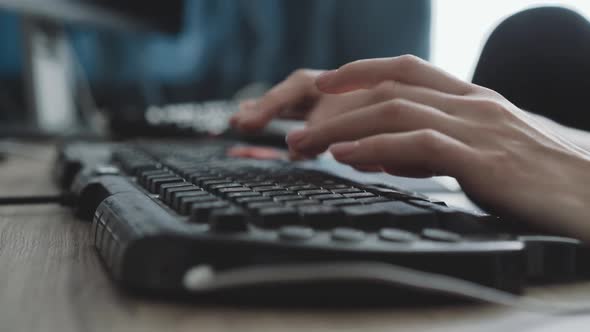 View of Female Hands Typing Fast on Keyboard on Blurred Background alt