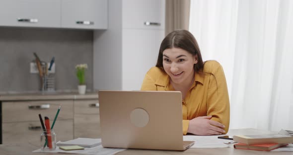 Woman Talking on Video Conversation on Laptop Waving Hello Joyfully Gesturing Hands Smiling Sitting alt