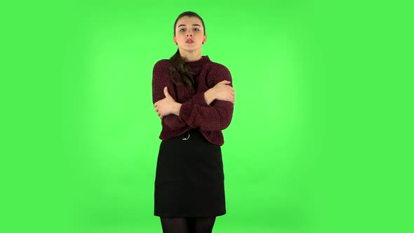 Beautiful Sweet Girl Froze and Trying To Keep Warm Against Green Screen. Green Screen alt