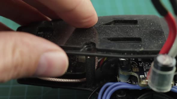 Extreme Close Up of Young Man's Hands Assembling FPV Racing Drone Using Screwdriver.