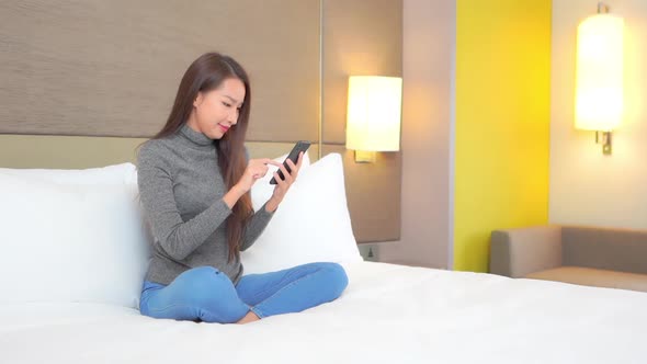 Young asian woman use smart phone alt