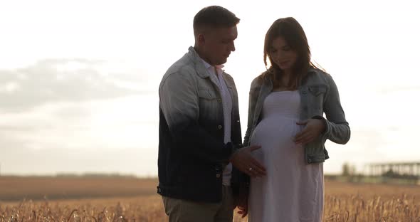 Smiling Parents Couple Enjoying Pregnancy While Kissing