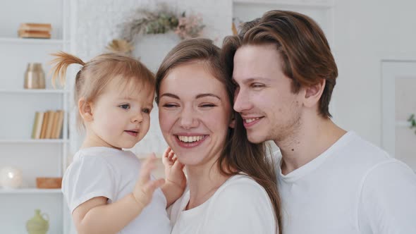 Portrait Caucasian Family Young Mother Millennial Father Loving Parents Hold Little Girl Child alt
