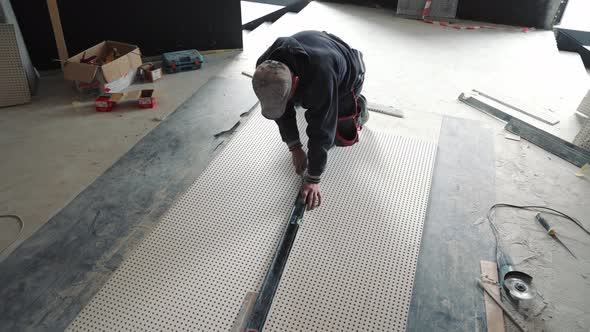 Master Builder Cutting a Form Out of Drywall alt