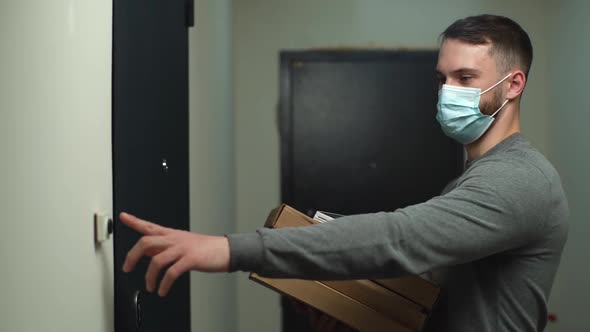 Courier in Medical Mask Coming To Door with Boxes with Hot Pizza and Rings Doorbell alt