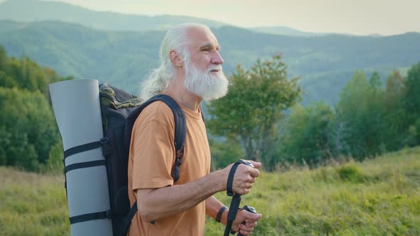 The Traveler Makes a Hike in the Mountains Enjoys Nature alt