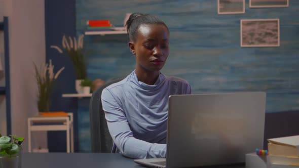 Africanamerican Woman Looking at Camera Smiling Working at Pc alt