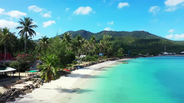Aerial drone panorama of tranquil tourist beach voyage by blue ocean with white sand background of a alt