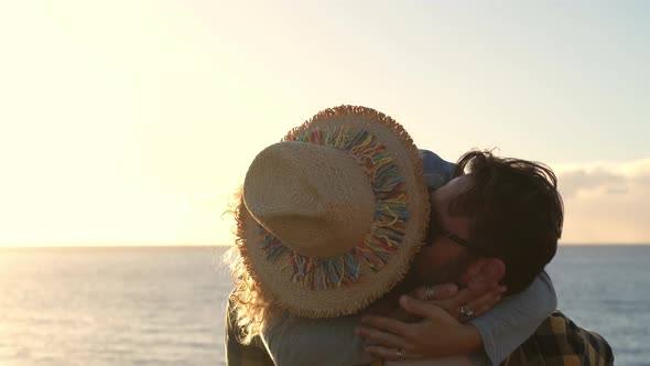Man carrying happy woman piggyback at the sea alt