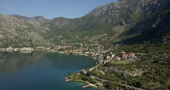 Aerial shot of Risan in Montenegro. ruins in the foreground on the bay of Kotor and mountains in the alt