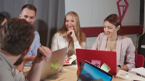 Cheerful Office Workers Are Meeting in Working Room in Evening alt