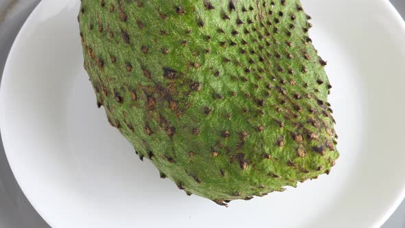 Closeup of Whole Green Soursop Graviola, Exotic, Tropical Fruit Guanabana on Plate alt
