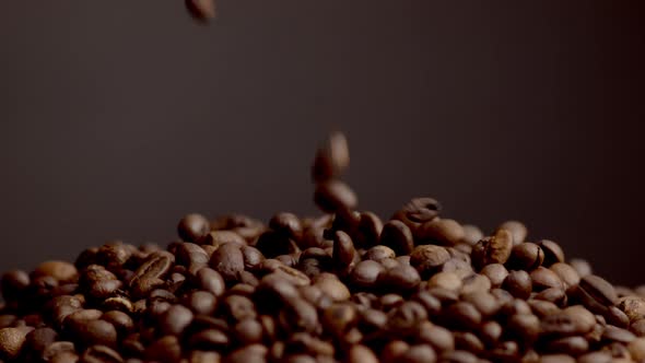 Coffee Beans Falling Down on Heap Close Up alt
