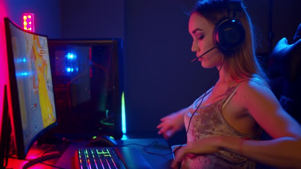 Sexy Young Gamer Woman Sitting By the PC and About To Play Video Game alt