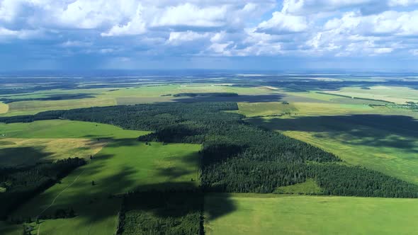 Aerial footage of a hayfield. Idyllic countryside landscape. Drone footage alt