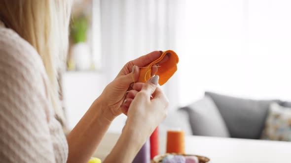 Tracking video of woman sews carrots at home. Shot with RED helium camera in 8K. alt