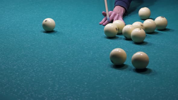 The player hits the balls. Game of billiards
