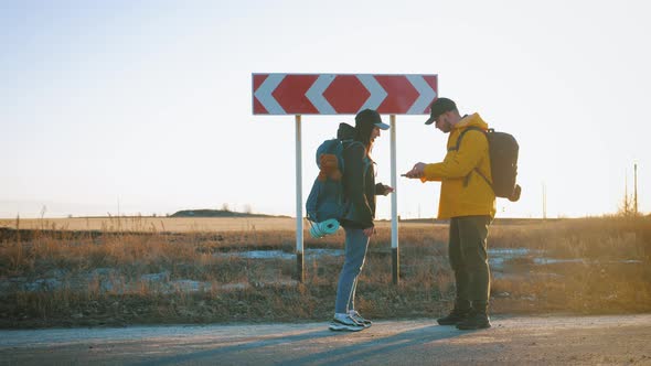 Young Tourists Couple Arguing About Best Path for Hiking Pointing and Choosing Right Direction alt