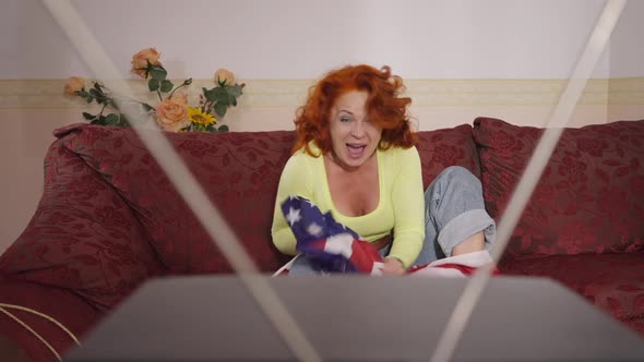 Positive Retro Woman Cheering Rejoicing Win Watching Sports Match on Vintage TV Sitting on Couch alt