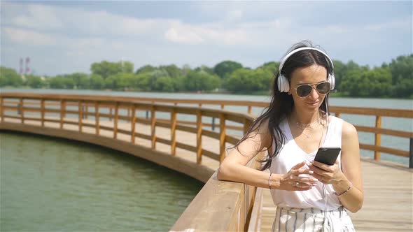 Happy Young Urban Woman Enjoy Music Outdoors