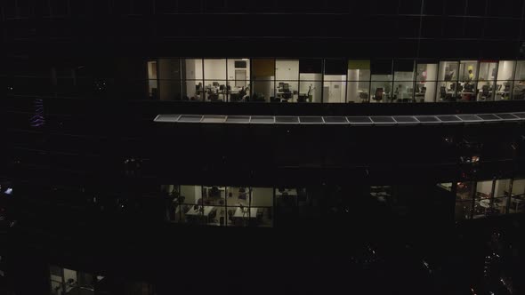 Aerial View From Drone on Glass Facade of Modern Skyscraper with Offices at Night alt