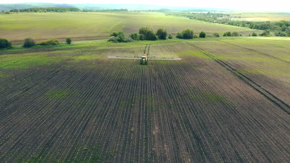 Aerial View Farm Machinery Spraying Insecticide To the Green Field, Agricultural Natural Seasonal alt