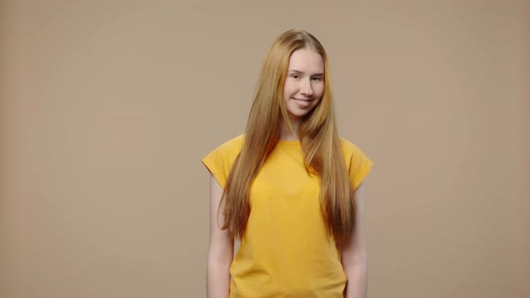 Portrait of a Model with Natural Beauty Coquettishly Looking at Camera and Smiling alt