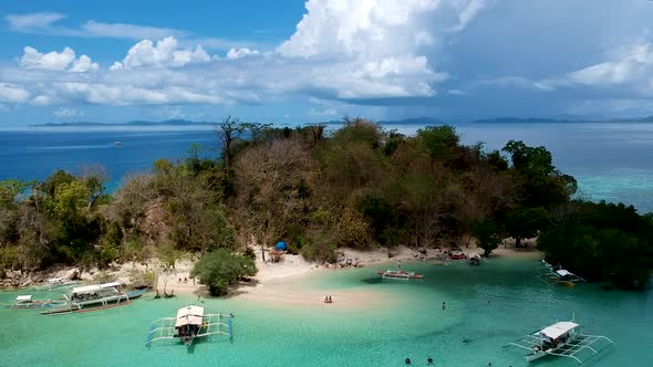 Aerial establishing shot of CYC beach on CYC Island, Coron town, Philippines alt